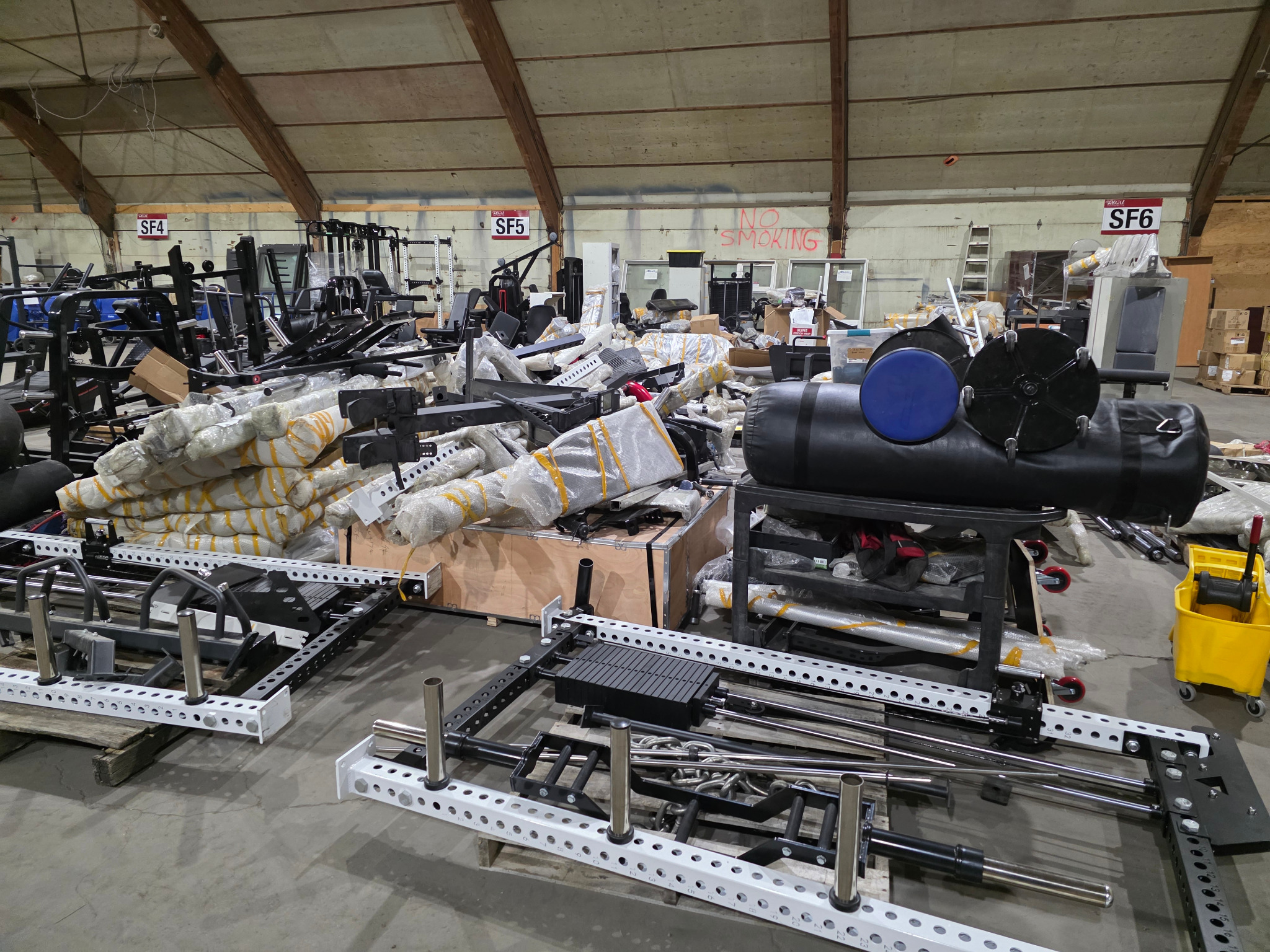 Fitness equipment and packaged components inside a warehouse during a Northmark assignment.